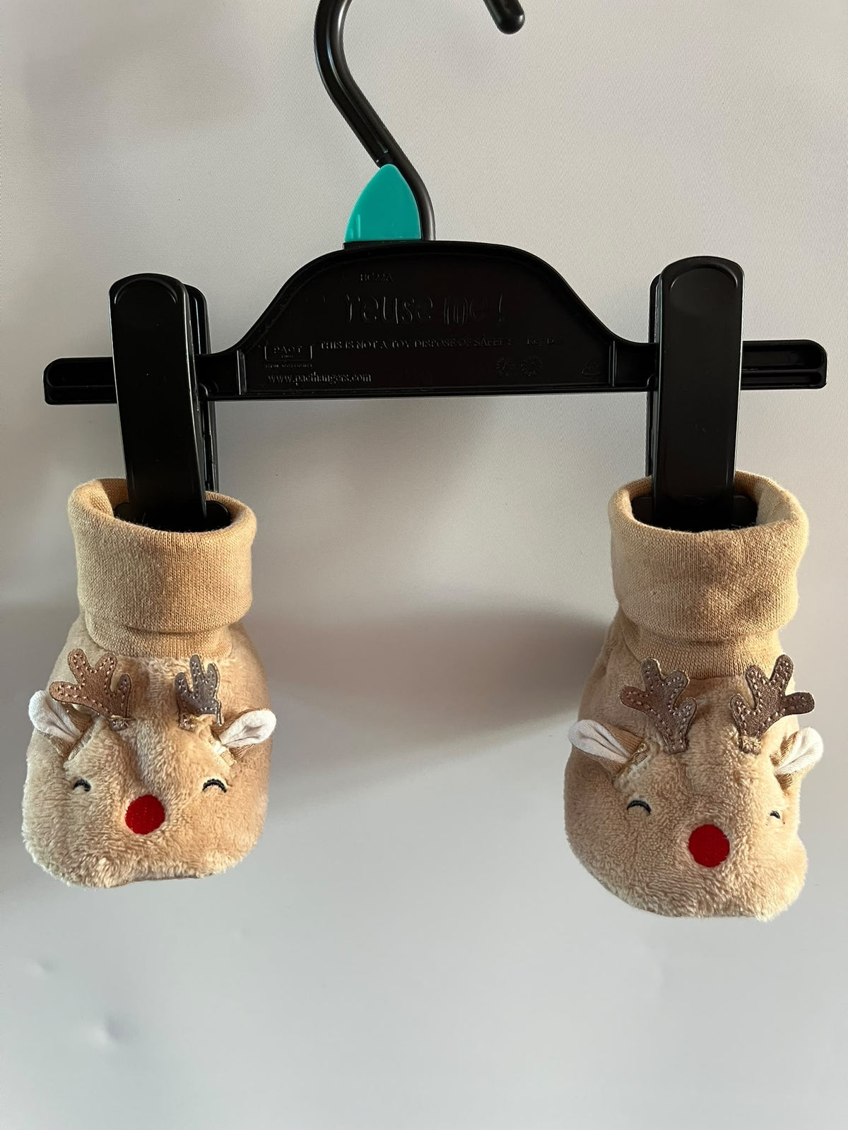 A pair of plush baby booties with reindeer facestu preloved little drums