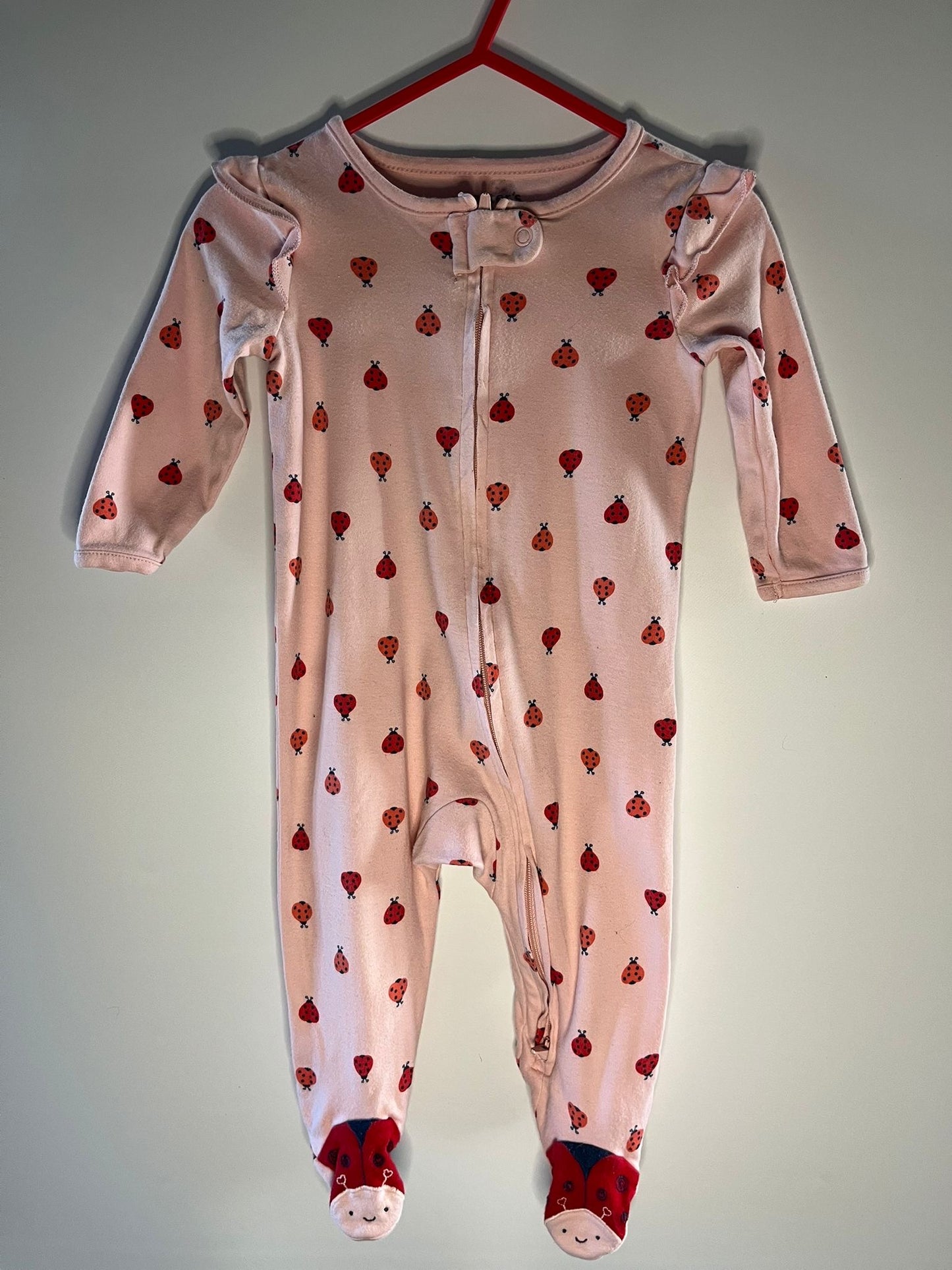 Pink baby onesie with lady bird patterns, preloved little drums