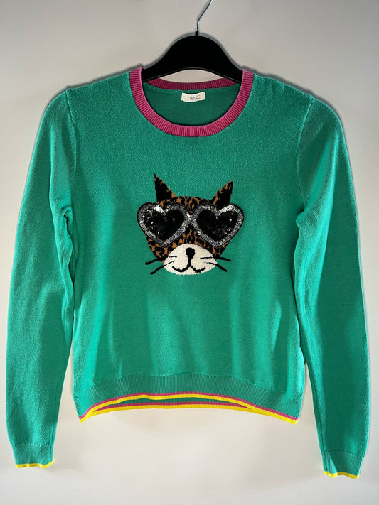 A green children's jumper with a graphic of a cat wearing glasses on the front. Next Preloved Little drums