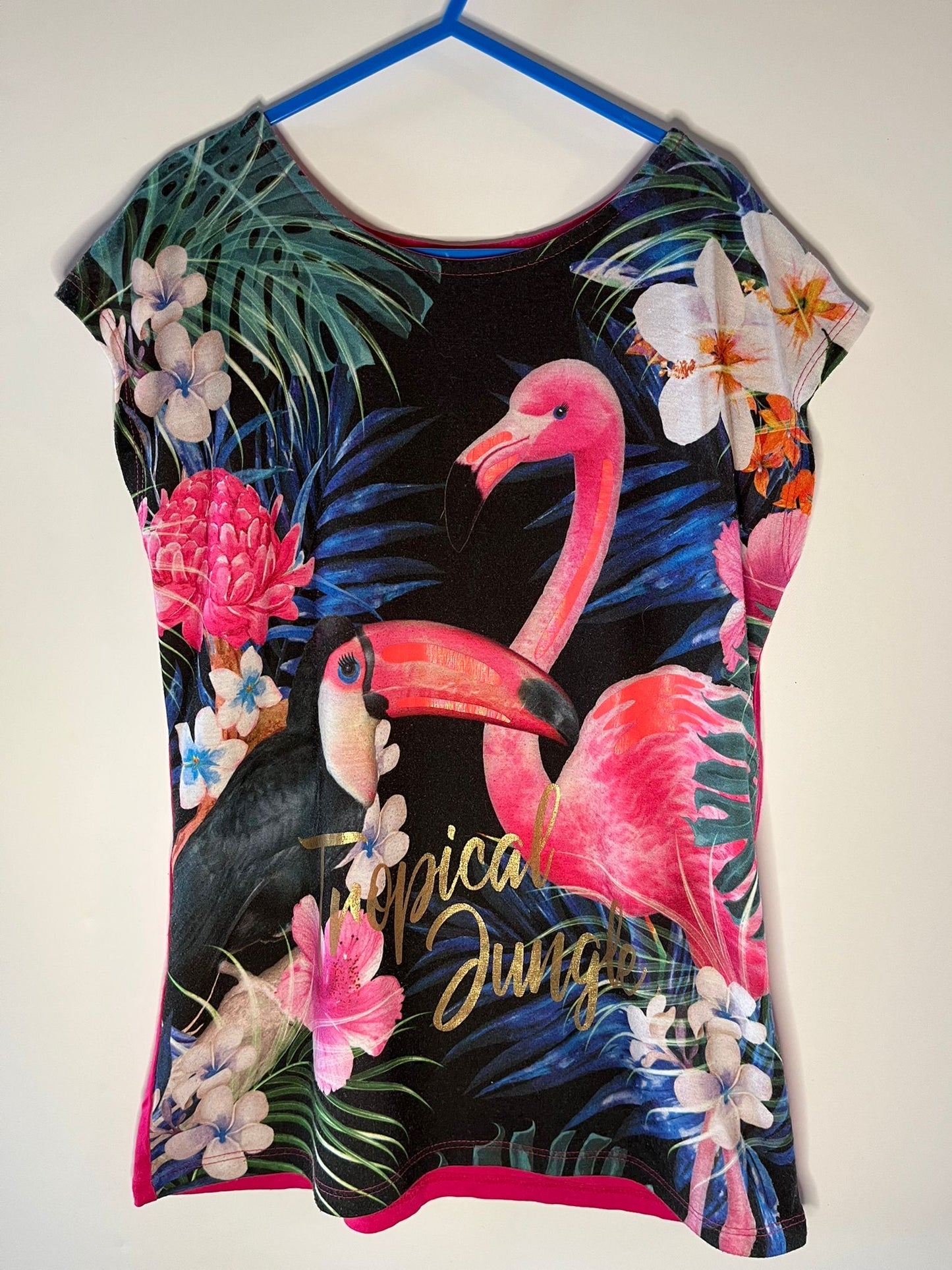 T-shirt with flamingo and tropical leaf design on a plain background