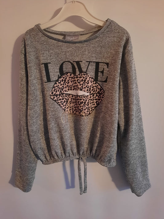 Matalan grey sparkle long sleeve top, word love written on it with lips. Preloved - Little Drums.
