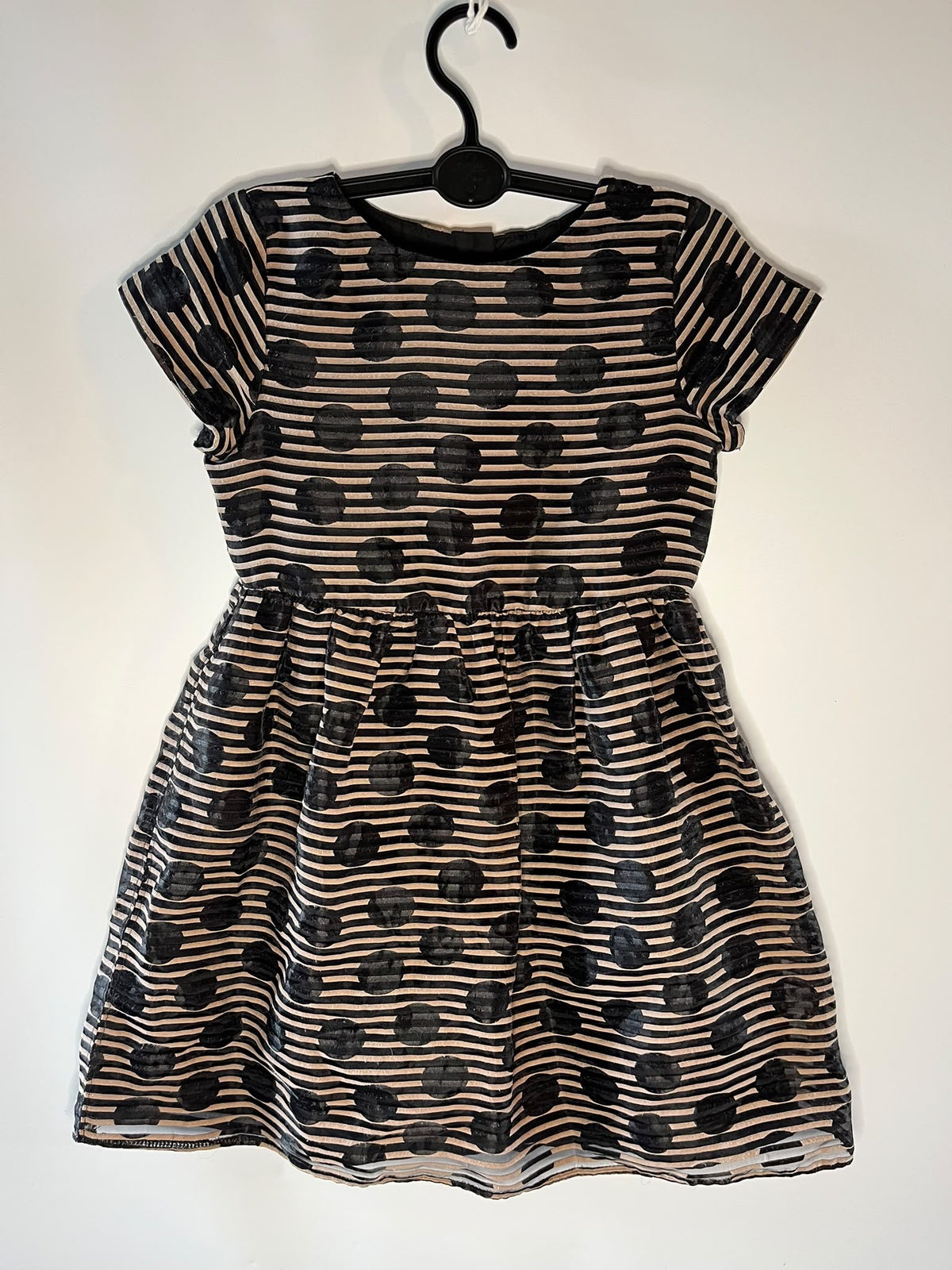 A short-sleeve children's dress with a black and brown horizontal stripe pattern and large black polka dots, little drums preloved next