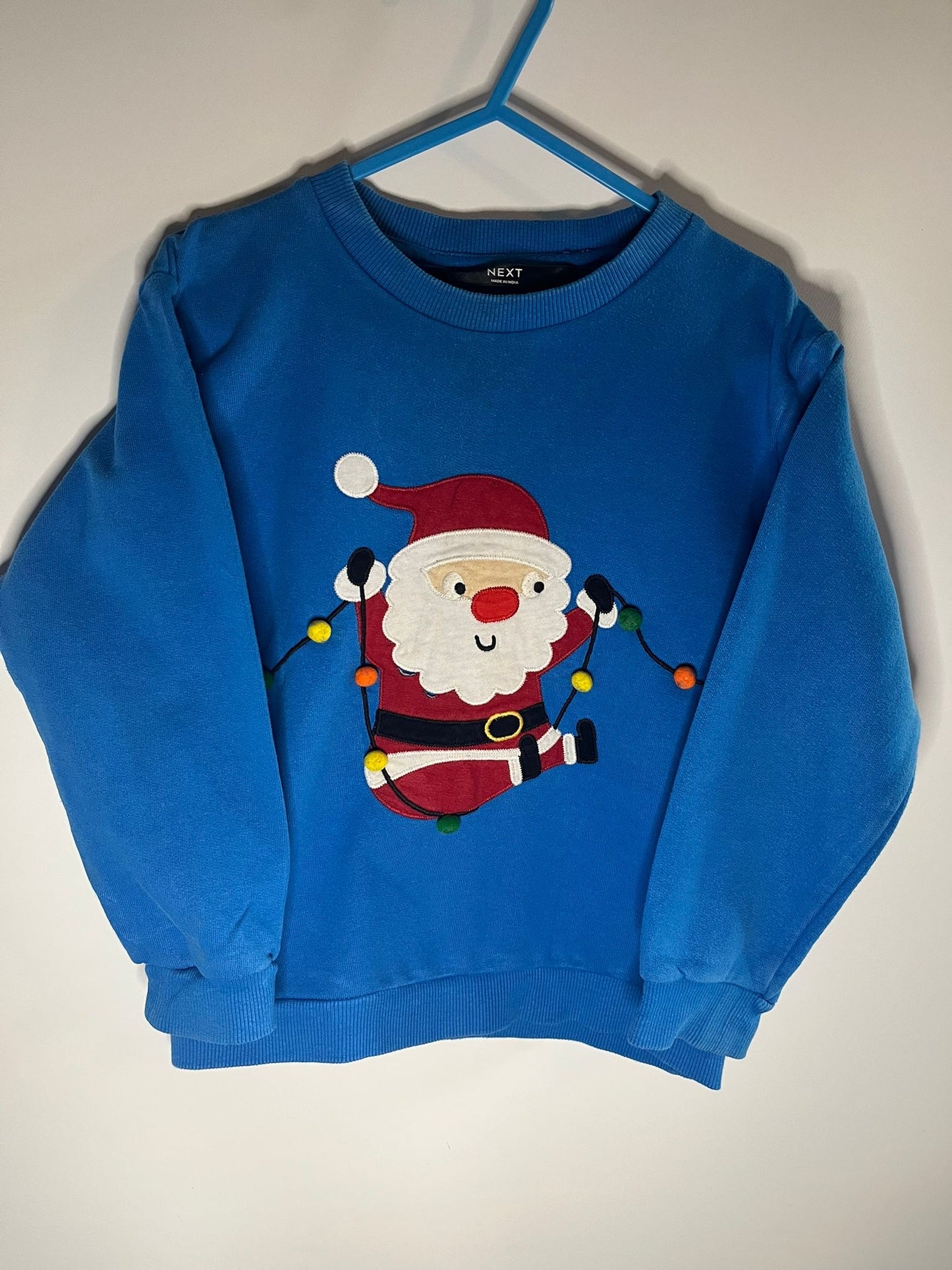 Blue sweater with Santa Claus next, size 3 to 4 years. Preloved, little drums