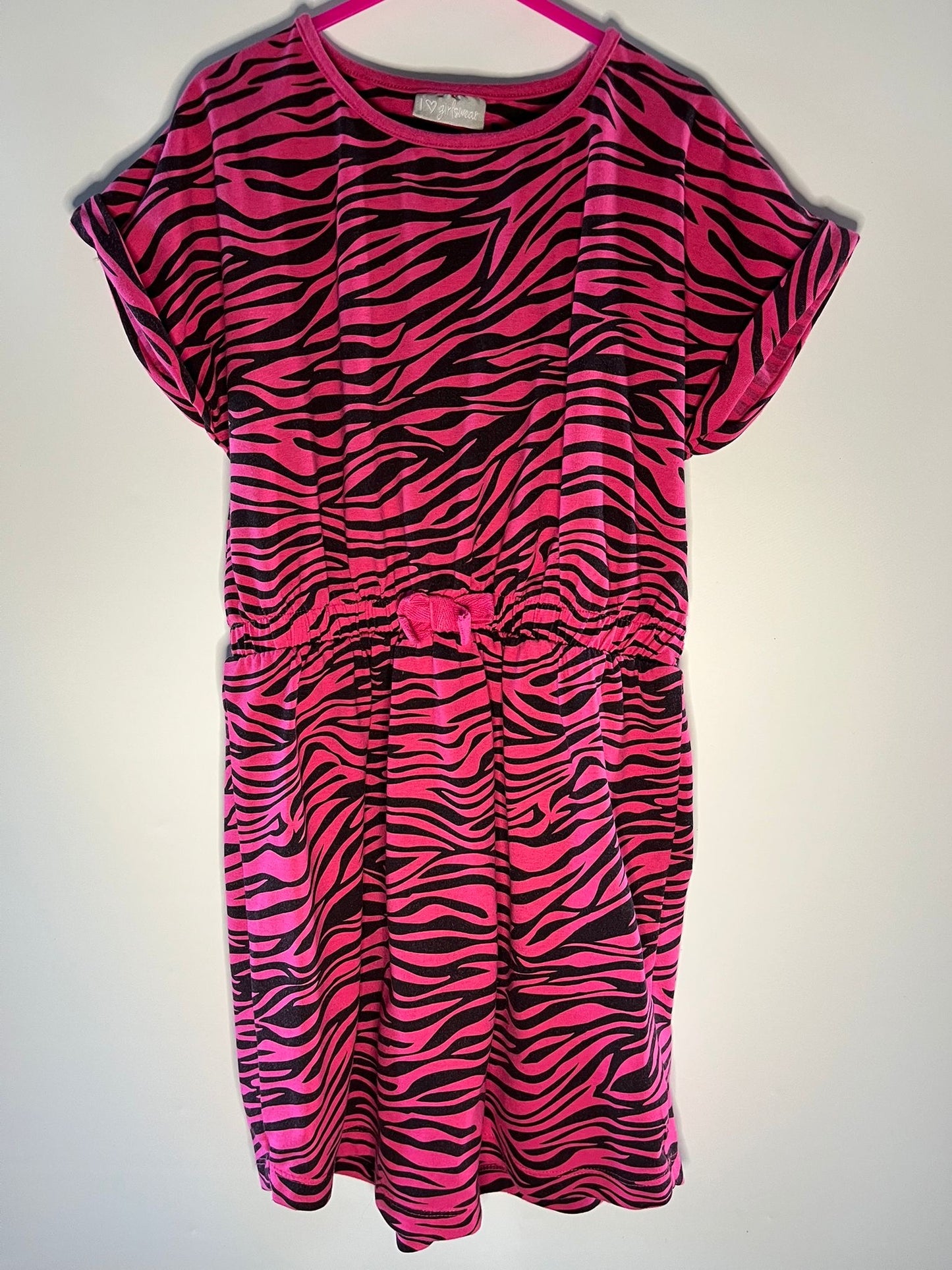 Pink and black zebra pattern dress on a white background. Matalan preloved children clothing little drums