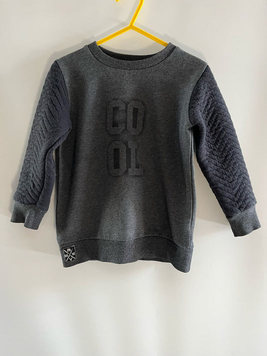 Very Dark grey jumper with wording "Cool". Preloved - Little Drums