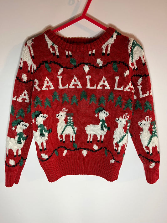 Red sweater with llama and 'ALALALA' pattern on a hanger against a white background