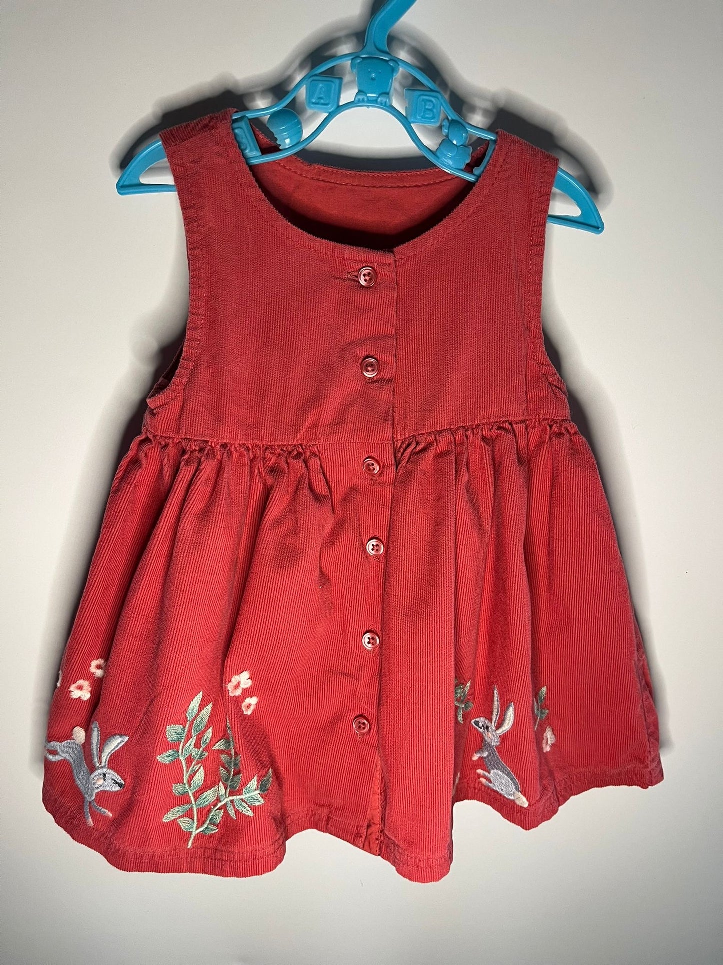 Preloved M&S coral dress with flowers and bunnies size 3 to 6 months. Little Drums