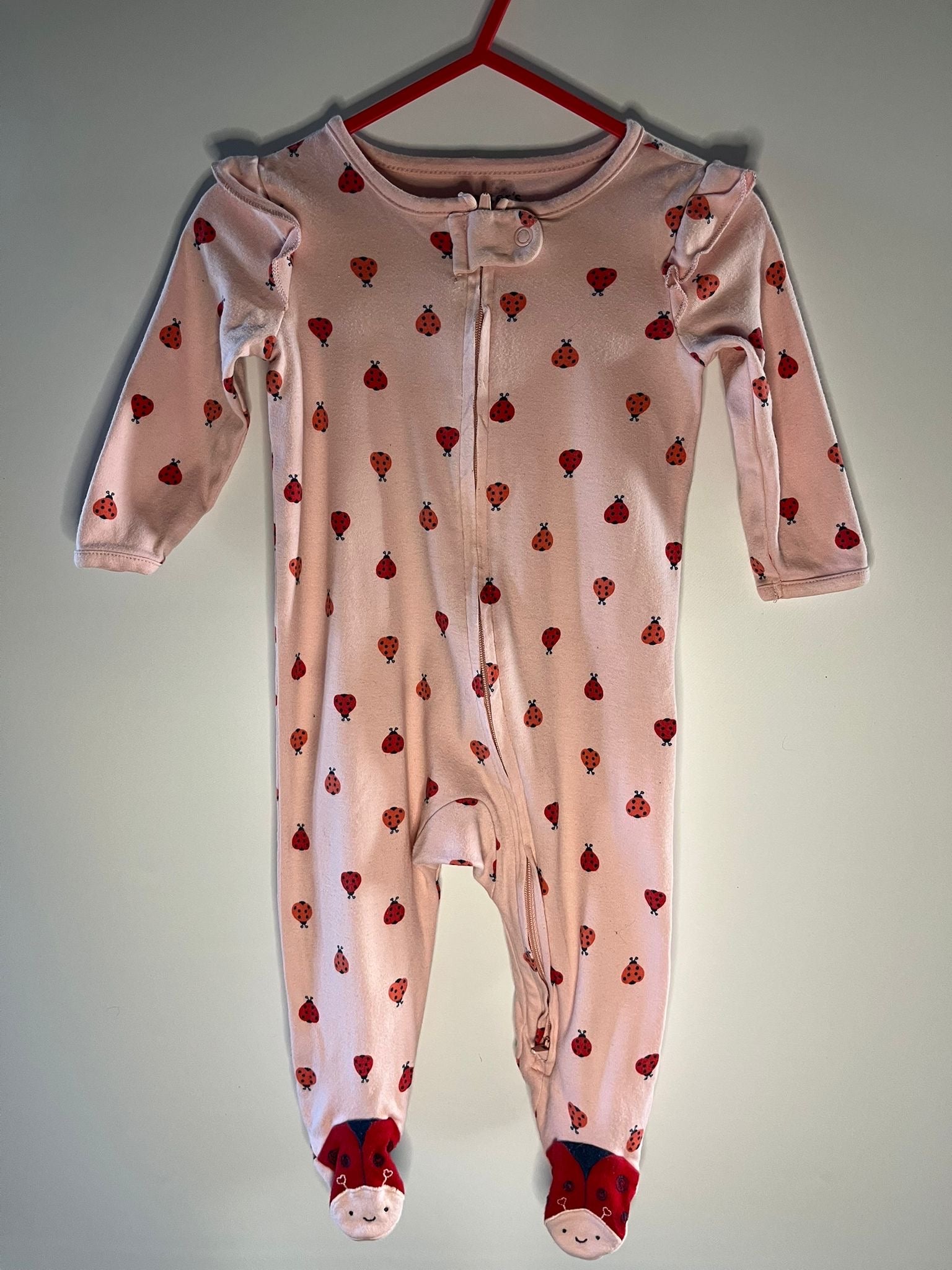 Pink baby onesie with lady bird patterns, preloved little drums 
