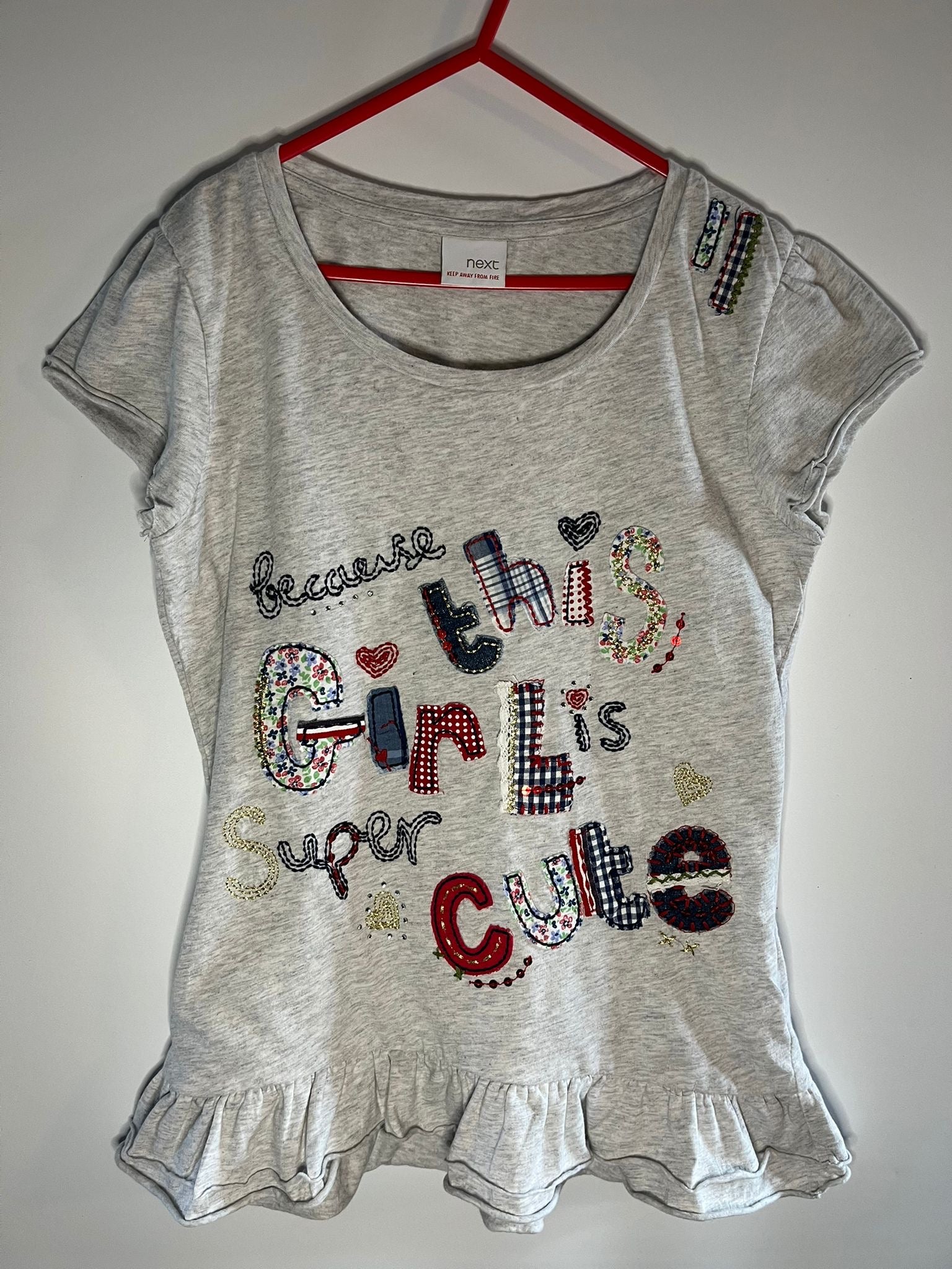 Gray t-shirt with colorful text and designs. Next, preloved little drums size 11 years 