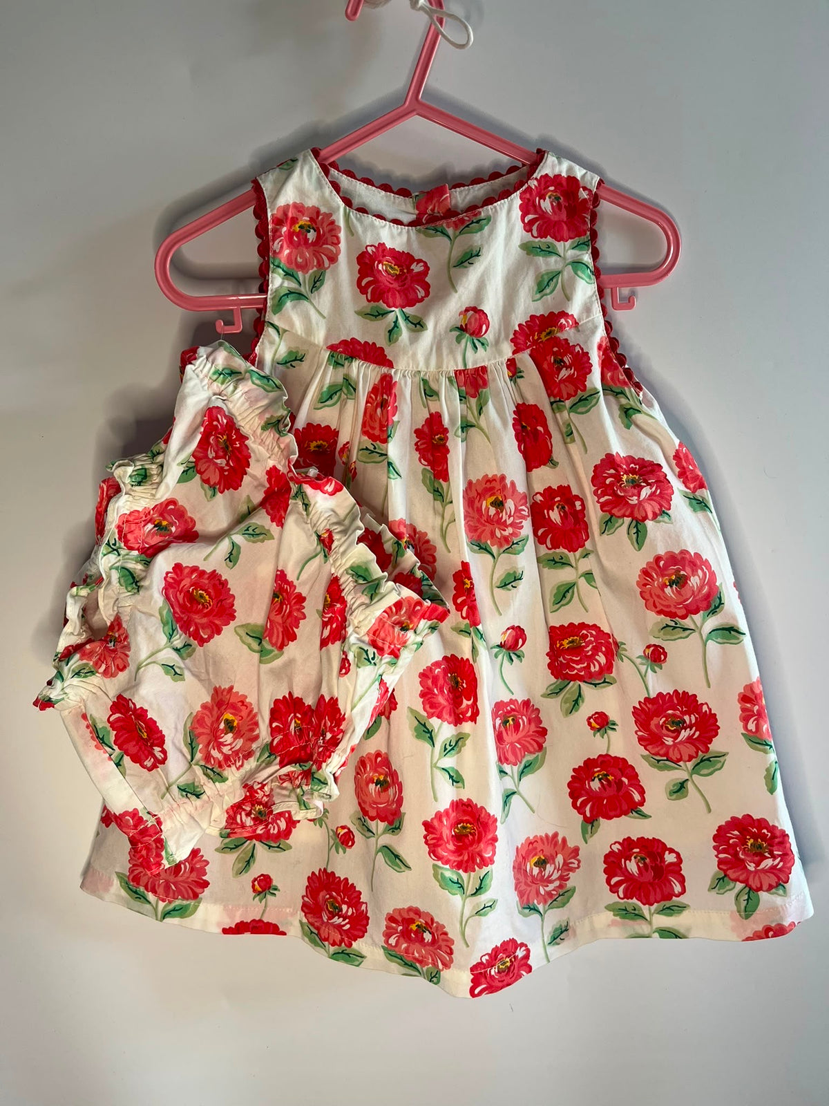 A sleeveless baby dress and matching smocked shorts set in a red and green floral print cath kidson baby 3-6 months preloved little drums 