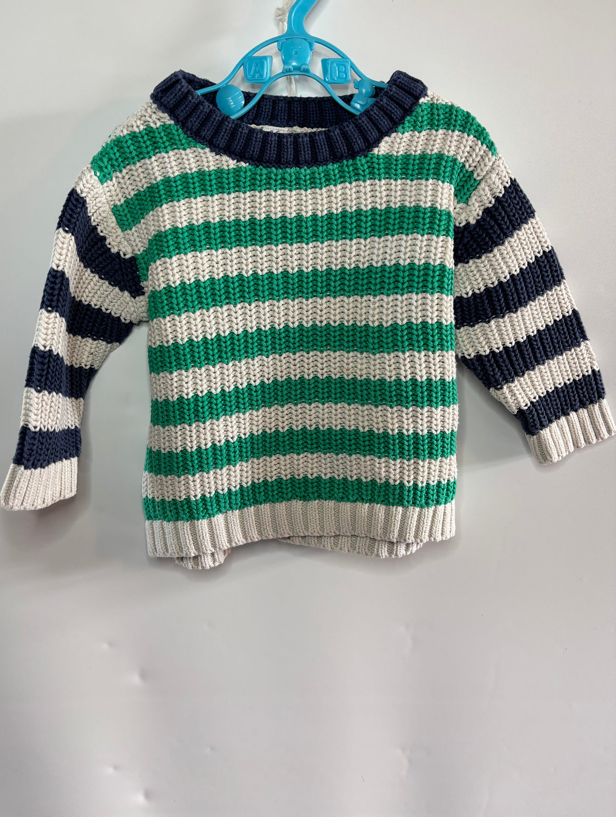 A baby knit sweater with horizontal stripes of green, off-white, and navy blue M&S preloved baby clothes little drums 