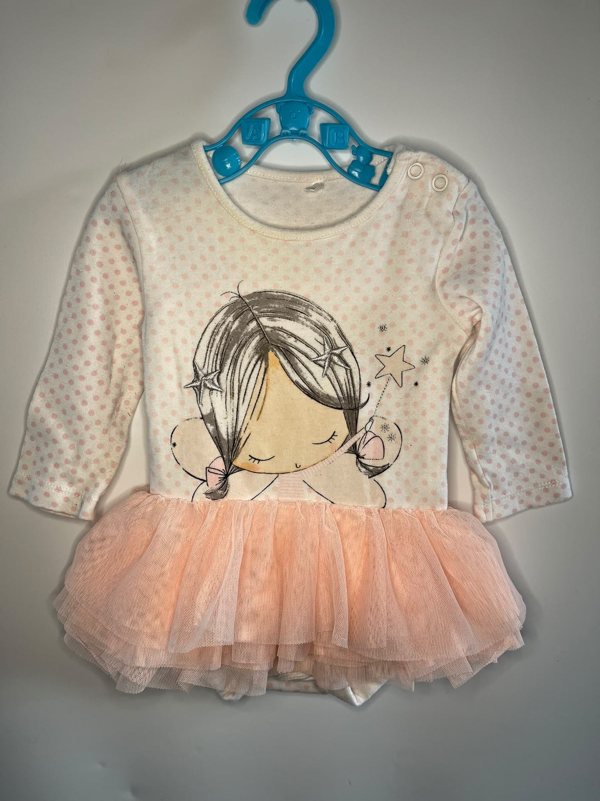 TU baby vest featuring a pink bodice with pink polka dots, a cartoon girl fairy graphic, and a layered peach tulle tutu skirt,