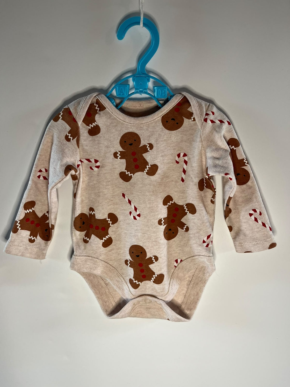 A baby long-sleeve bodysuit with a gingerbread man and candy cane print, F&F little drums preloved 