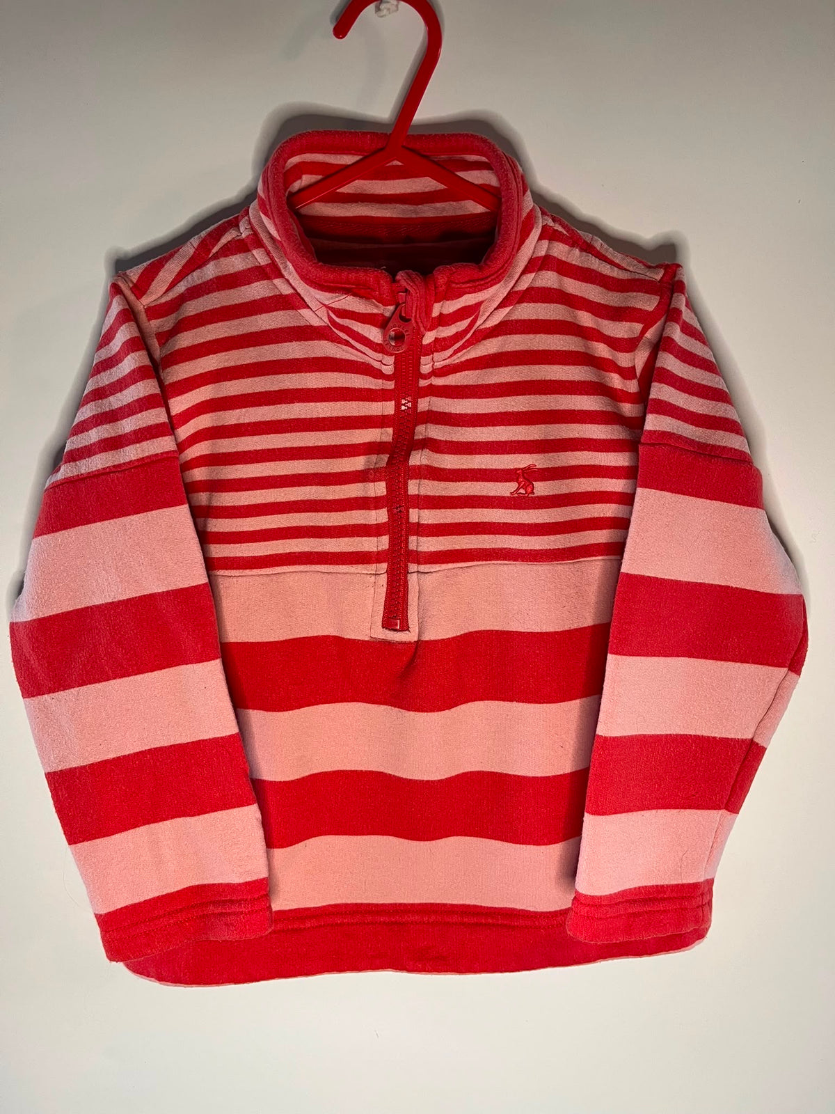 A red and pink striped long-sleeve quarter-zip pullover sweatshirt,
Joules preloved little drums 
