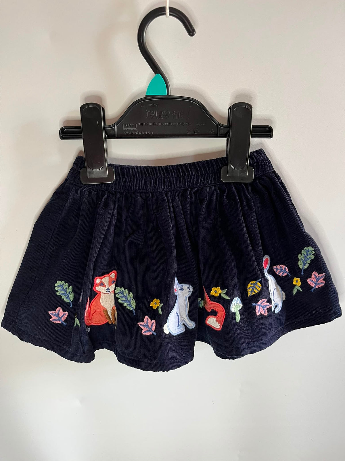 A dark navy blue corduroy skirt with embroidered animal and floral motifs - mini Boden 6-12 months little drums preloved 