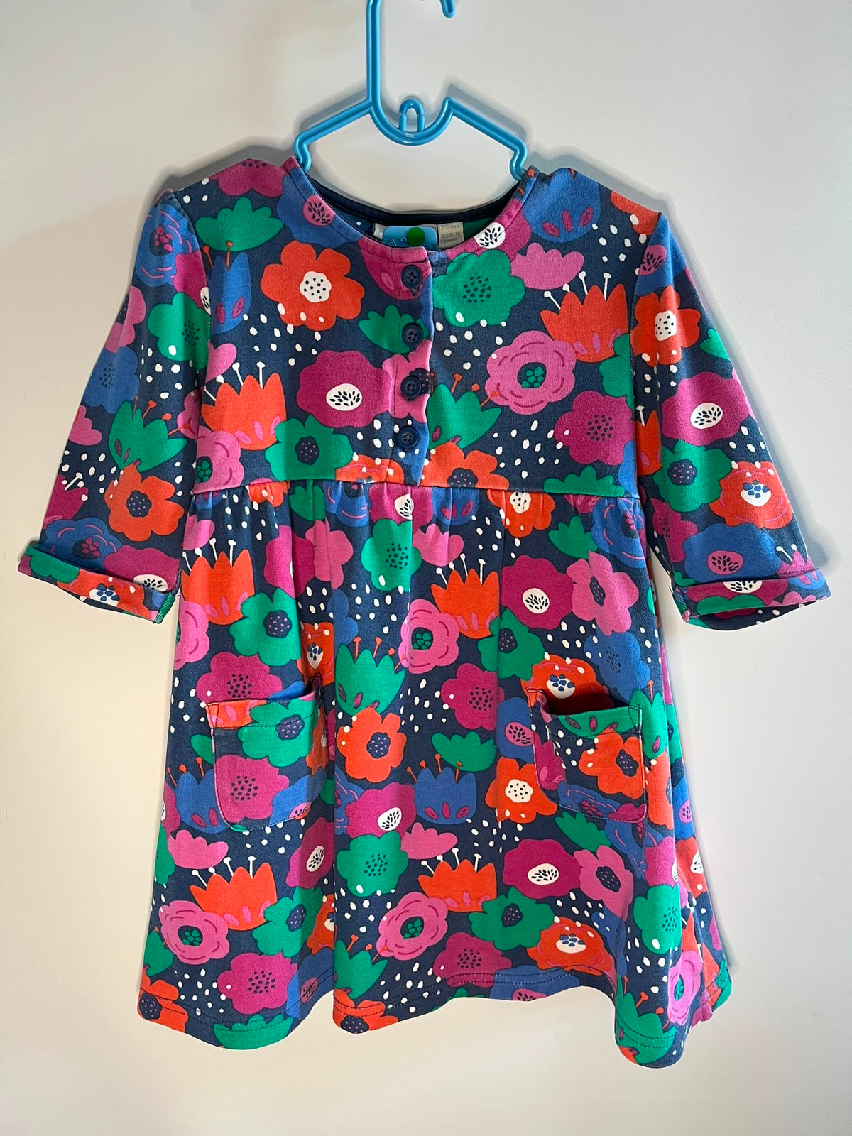 A short-sleeve button-front dress with a colorful floral print, Jojo maman Bebe dress 2-3 years preloved little drums 