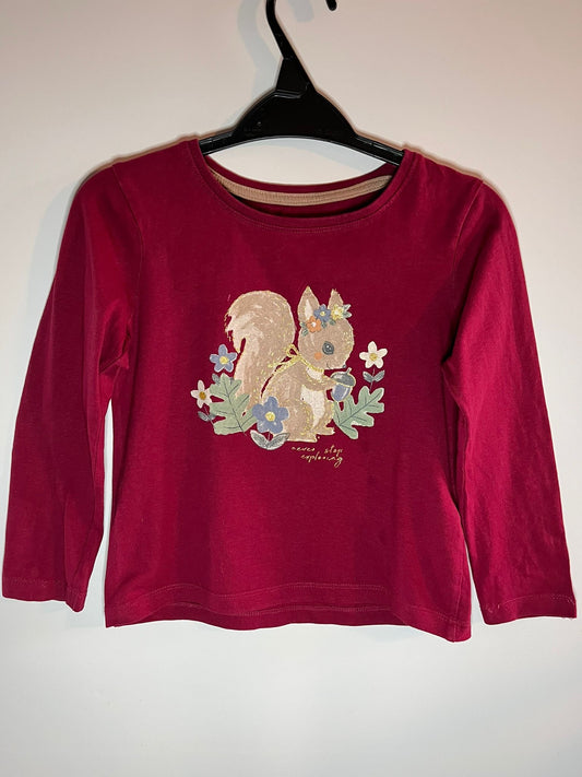 Red long-sleeve shirt with a squirrel design on a hanger against a white background - Primark size 5-6 - little drums preloved 