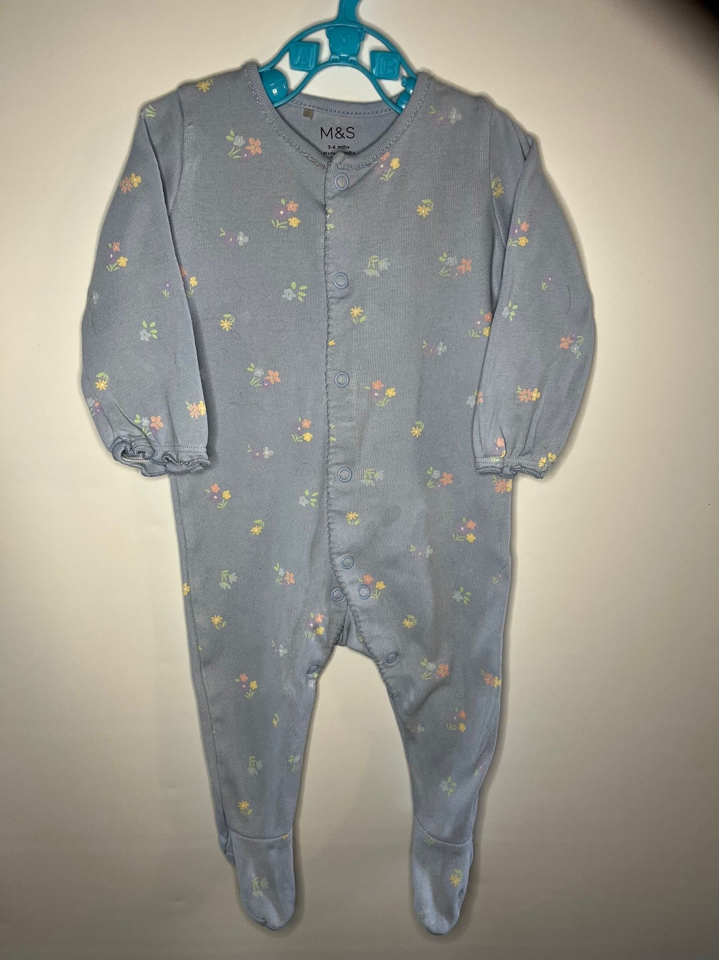 Blue baby onesie with floral pattern preloved little drums 