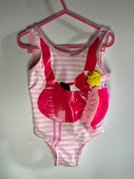 A pink and white striped girl's one-piece swimsuit with a glossy pink flamingo applique and a pink ruffled headband with a yellow pom-pom flower, TU preloved little drums 
