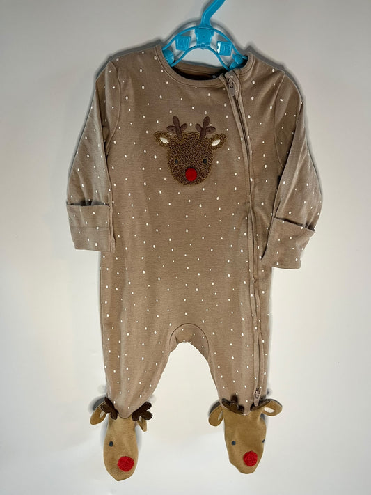 A baby footed one-piece sleeper in a warm taupe-brown color with white polka dots, featuring an applique reindeer face on the chest and matching reindeer feet with red noses, M&S preloved little drums.