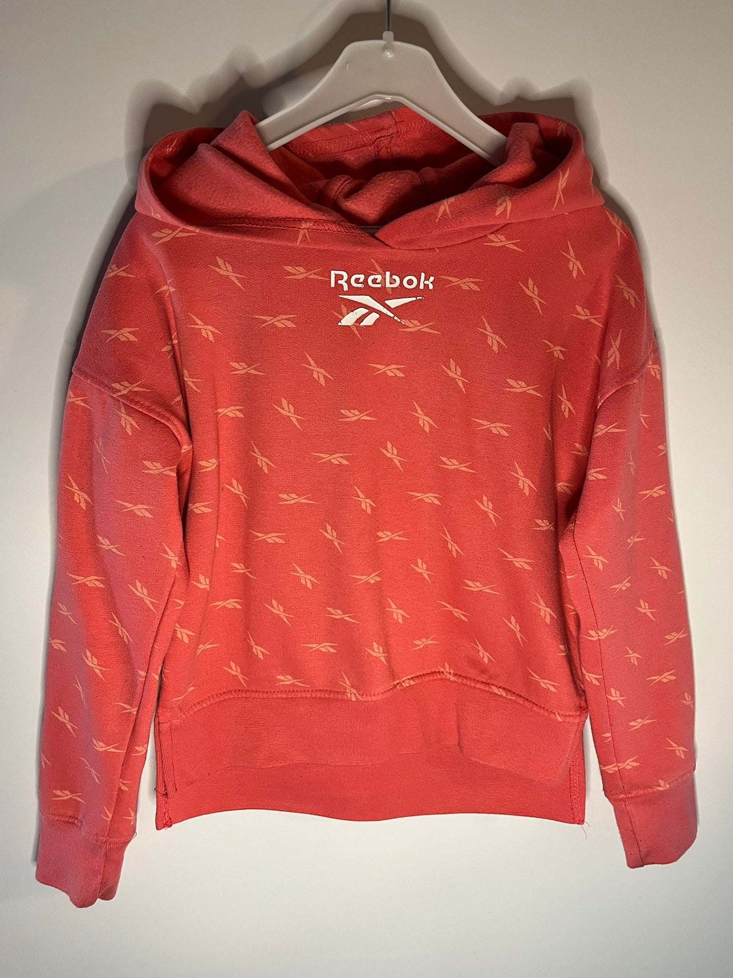 Red Reebok hoodie with small white logo on a white background