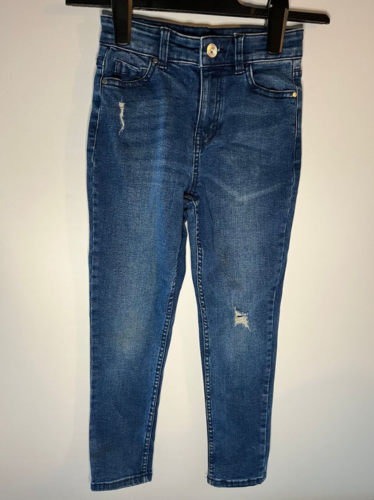 Blue jeans with slight distressing on a white background next, preloved little drums