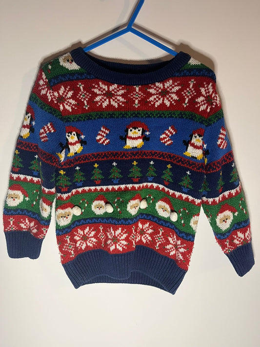 Colorful Christmas-themed sweater with penguins and Santa Claus from George, preloved little drums